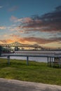 The Horace Wilkinson Bridge over the flowing waters off the Mississippi River with boats on the water, lush green grass Royalty Free Stock Photo