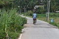 Horana,Kalutara District, Sri Lanka_February 25 2022: A mature man pedaling a bicycle on a concrete road