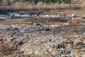 Poor people collecting garbage at city garbage dump. Pile of plastic trash, food waste on landfill. Concept of poverty and Royalty Free Stock Photo