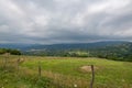 Horizon Jewel: Blue Skies Adorn Majestic Green Mountains Royalty Free Stock Photo