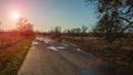 Horizon, meadow and asphalt road evening landscape