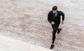 Horizontal above view image of young athelte man running in the morning on the fog lake background. Fitness male exercising in the Royalty Free Stock Photo