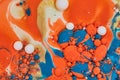 Horizontal abstract butterfly of oil spill of golden cream mixing with orange and blue acrylic paint in background asset Royalty Free Stock Photo