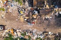 Horizontal aerial shot of a garbage dump with stacks and piles of rubbish.