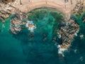 Horizontal aerial view of Conchas Chinas Beach in Puerto Vallarta. Bright clear turquoise water at beach