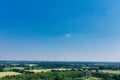 Horizontal aerial view to the horizon with blue sky, much copy space, a small cloud