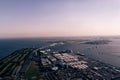 A horizontal aerial view of the Tokyo Gate Bridge in Tokyo Bay from a helicopter at sunset in spring