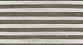 Horizontal alternating stripes of white and gray-brown create a pattern resembling a Royalty Free Stock Photo