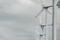 Wind turbine with grey sky and clouds. Wind energy in eco wind farm. Green energy concept. Renewal energy. Alternative electricity Royalty Free Stock Photo