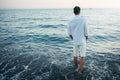 Horizontal back view of man wearing white shirt and pants on the Royalty Free Stock Photo