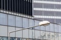 Horizontal background with building windows. Close up architecture abstracts from office buildings and public lamp in front. .