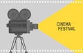 Horizontal background for cinema festival with retro camera or movie projector standing on tripod and film perforation Royalty Free Stock Photo