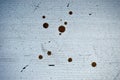 Horizontal background of dirty white wooden surface with scuff and round brown spots.