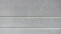 Horizontal banded gray wall with rough stucco texture and clean, shallow lines separating sections Royalty Free Stock Photo