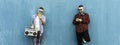 Horizontal banner or header with cool men looking at mobile phone lean against blue wall - Couple of influencer guys listening Royalty Free Stock Photo