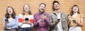 Horizontal banner or header with group of happy friends having fun with mobile smartphones outdoors - Young people laughing Royalty Free Stock Photo