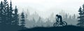 Horizontal banner. Silhouette of mountain bike rider on meadow in forrest. Silhouette of biker, trees, grass. Magical misty land Royalty Free Stock Photo