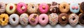 horizontal banner with Top view of assorted glazed colorful donuts with icing as background