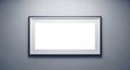 Horizontal black framed empty white picture frame on gray wall blank Royalty Free Stock Photo