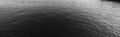 Horizontal black and white gloomy surface of the water