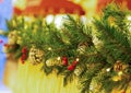 Horizontal border branch of fluffy green fir with cone and red holly berries with perspective street decoration celebrating