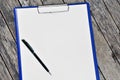 Horizontal clipboard with blank white paper and pen Royalty Free Stock Photo