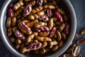 Horizontal close up of boiled peanuts or groundnuts, macro shot of peanuts, some shelled with pink groundnuts visible