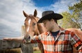 Close up of young cowboy posing with his horse.