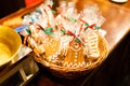 The horizontal close-up view of the Christmas cookies placed in the straw basket in the shop.