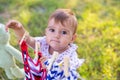 Horizontal closeup portrait of a cute little girl playing outdoors