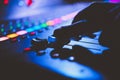 Horizontal closeup shot of an audio music mixer and sound equalizer while DJ working on it