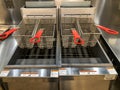 A horizontal closeup view of a deep fryer in a commerical kitchen