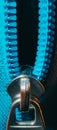horizontal closeup of the zipper of a stylish blue.