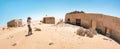 Horizontal crop of adventurous traveler photographer at Kolmanskopp ghost village near Luderitz in Namibia - Wanderlust and travel