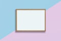 Horizontal empty wooden frame on pink and blue pastel background , blank frame mock up with copy space Royalty Free Stock Photo