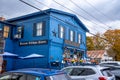 Horizontal fall view of the two-story blue wooden Weston Village Store in the quaint village of