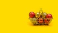 horizontal festive yellow background with copy space: toys on the Christmas tree in a shopping basket