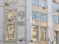 Part of the facade of an old building. Cracks and chips of plaster are visible.