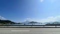 Horizontal green mountain, island, boats, lake, blue sky, road natural photography