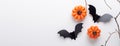 Horizontal Halloween banner. Black paper bats and pumpkins on white background. Top view, copy space Royalty Free Stock Photo