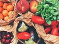 Horizontal high angle shot of vegetables and a variety of fruits in paper bags