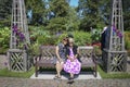 Mother and grown daughter sitting on a park bench in the park