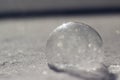 Horizontal image of frozen bubble in sparkly snow