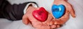 Horizontal image hands of bride and groom holding stones with love and happiness words