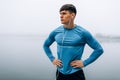 Horizontal image of handsome young athlete man posing outdoor in the morning on the fog nature background during running. Fitness Royalty Free Stock Photo