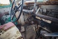 horizontal image of the inside of the front of a very old broken down bus