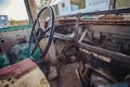 horizontal image of the inside of the front of a very old broken down bus