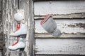 Small girl`s skates with red shoelaces hanging on a doorknob Royalty Free Stock Photo