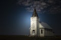 light shining on old country church at night time. Royalty Free Stock Photo