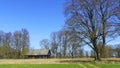 Horizontal image of an old rustic abandoned house and trees on nature background. Countryside concept Royalty Free Stock Photo